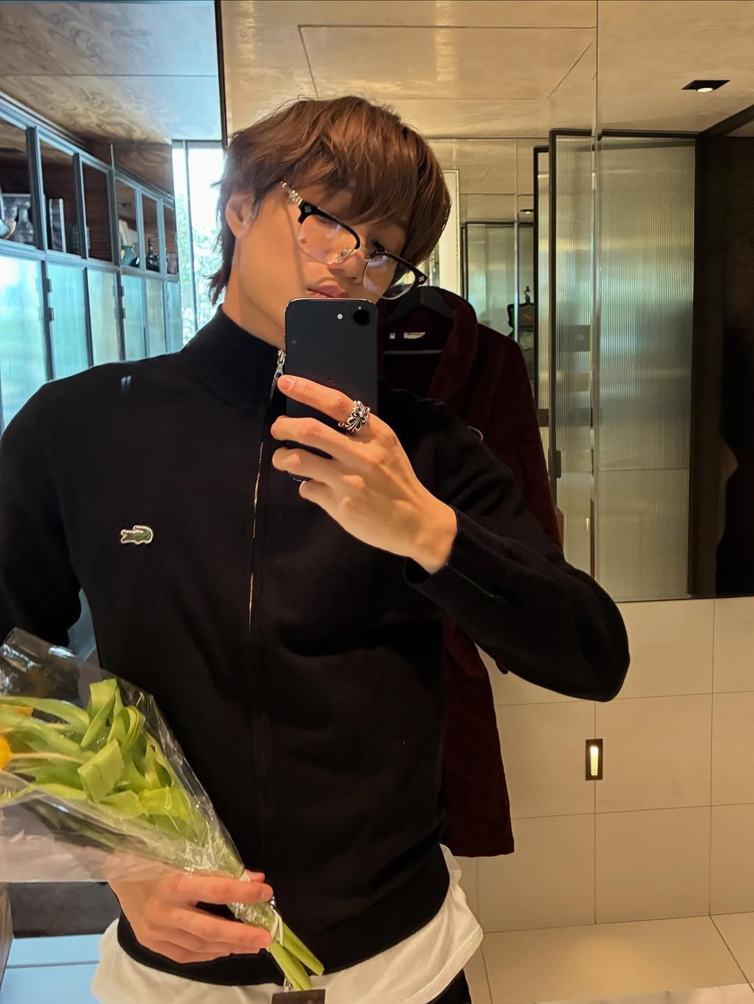 Photo shared by KAI on March 08, 2026 tagging @lacoste. May be a selfie of eyeglasses, mirror, white lily, prairie gentian, baby's-breath, rose and text.
