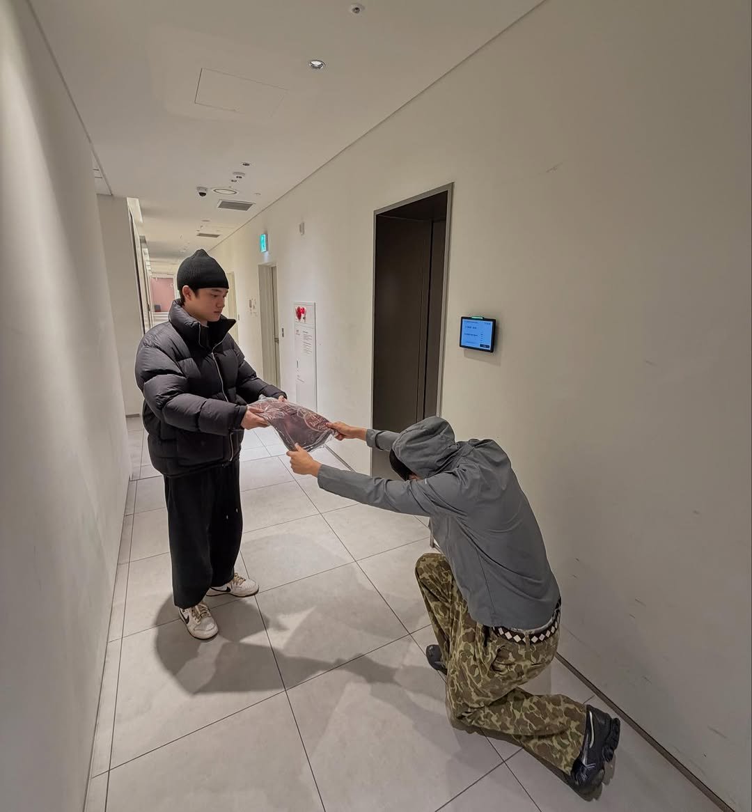 Photo shared by KAI on January 16, 2026 tagging @d.o.hkyungsoo. May be an image of standing, military uniform, sling and text.